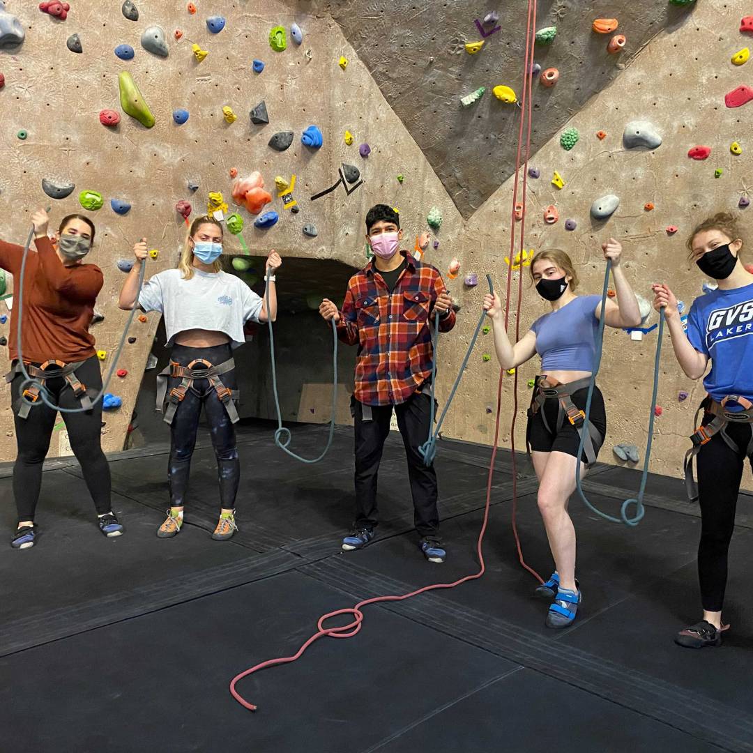 Image of five WIT peer educators at the climbing wall.